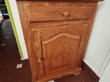 a small wooden cabinet in the corner of a room