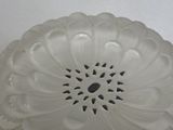 a white glass bowl with a flower design on it