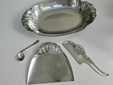 a silver plate with spoons and spoon rest on a table