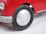 a red toy car that is sitting on a white surface