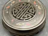 a silver box with a design on it on a table
