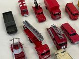 a lot of toy cars and trucks that are on the table