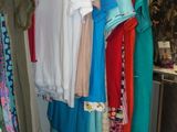a lot of clothes hanging on a rack in a room