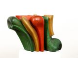 a sculpture made of different colored pieces on a white pedestal
