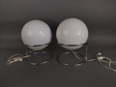 pair of white glass globe lamps with metal bases