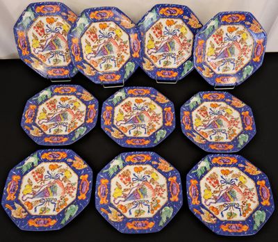 six blue and orange plates with flowers on them on a table