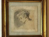 portrait of a young woman in profile, in a gold frame