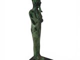 a green statue of a woman with a hat on her head