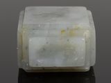 a close up of a white marble block on a black surface