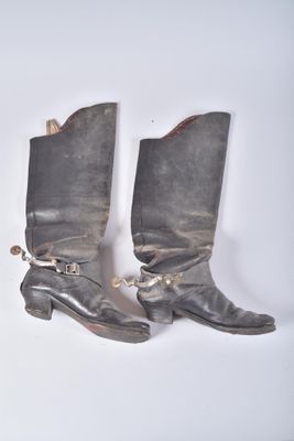 two pairs of boots that are sitting on a table