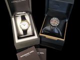 a box with a watch inside of it on a black surface