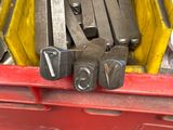a lot of tools in a yellow container on the street