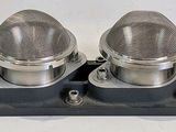 four light bulbs sitting on top of a metal holder