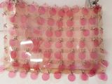 pink and white polka dot purse hanging on a white wall