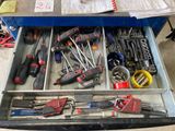 a drawer full of tools that are sitting on a table