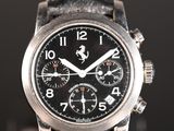 a close up of a watch on a black surface