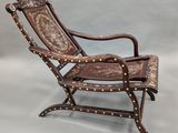 an image of a brown leather chair with rivets and studding