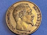 an old coin with a man ' s face on it on a blue surface