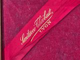 a close up of a red box with a ribbon in it