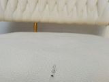 the back of a white chair with a cushion on top of it
