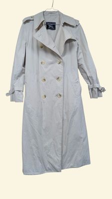trench coat on a hanger on a white background