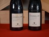 two bottles of wine sitting next to each other on a table