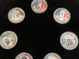 six commemorative coins in a display case with a red box
