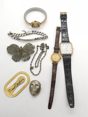 an assortment of jewelry including a watch, bracelet, and other items