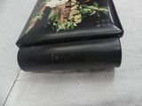 a black box with a picture of a bird and flowers on it