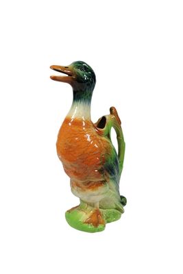 a figurine of a duck on a white background