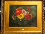 une photo d'un tableau de fleurs dans un cadre doré