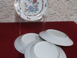 three plates that are sitting on a red table
