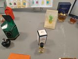 many bottles of perfume on a table next to each other
