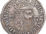 a close up of a silver coin with a crown on it