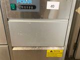 an image of a stainless steel dishwasher sitting on top of a wooden table
