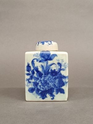 a blue and white vase with a flower design on it