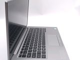 a silver laptop with a black keyboard on a white surface