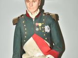 a statue of a man in a military uniform sitting on a stool