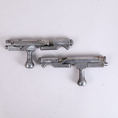 deux armes posées sur une surface blanche