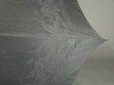 a black umbrella with a white lace pattern on it