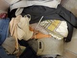a pile of clothes that is sitting on a bed