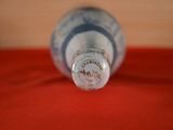 a close up of a bottle of water on a red surface