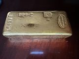 a gold bar sitting on top of a wooden table