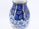 a blue and white vase with blue flowers on it
