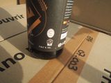 a bottle of beer sitting on top of a cardboard box