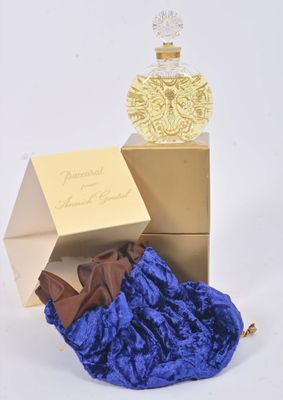 un flacon de parfum posé à côté d'un sac bleu