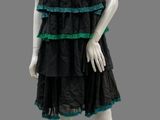mannequin dressed in black and green dress with green trim