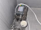 a water meter in the corner of a room