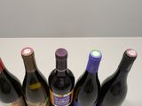 several bottles of wine are lined up in a row on a table