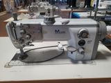 a white sewing machine sitting on a table in a room